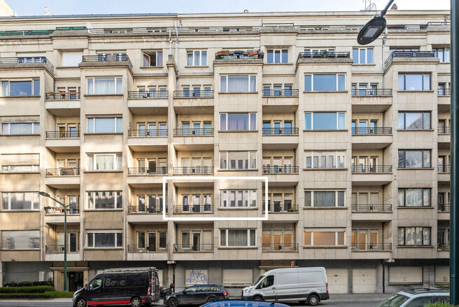 This classy one-bedroom apartment with a 2 terraces and 2 spacious attic storerooms is located on the 2nd floor of a co-ownership building, perfectly situated in the European Quarter, between Schuman and Brussels Park.

The apartment is arranged as follow