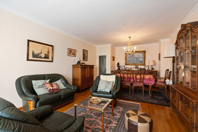 This spacious 2-bedroom apartment, featuring 2 terraces, a private garage box, and a parking space, is located on the third floor of a well-maintained residential building.

LAYOUT:
The entrance hall leads to a bright living room with a dining area and a 
