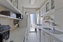 This bright 2-bedroom apartment with a 16 m² terrace is located on the 4th floor and offers lovely green views. Nestled in a quiet residential area, it offers comfort and privacy.

The entrance hall with built-in closets leads to a separate kitchen and a